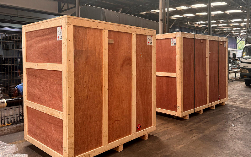 Large wooden crates sealed for secure industrial cargo transport.