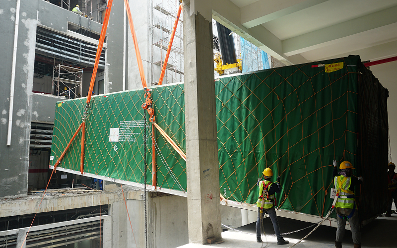 Construction-workers-lifting-heavy-cargo-in-industrial-logistics-operation