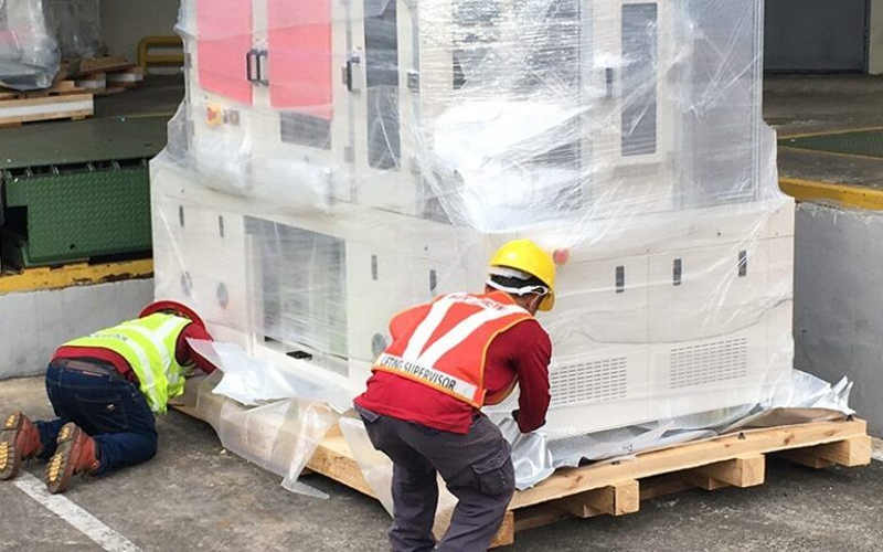 Forklift-loading-wrapped-healthcare-machinery-onto-a-cargo-truck